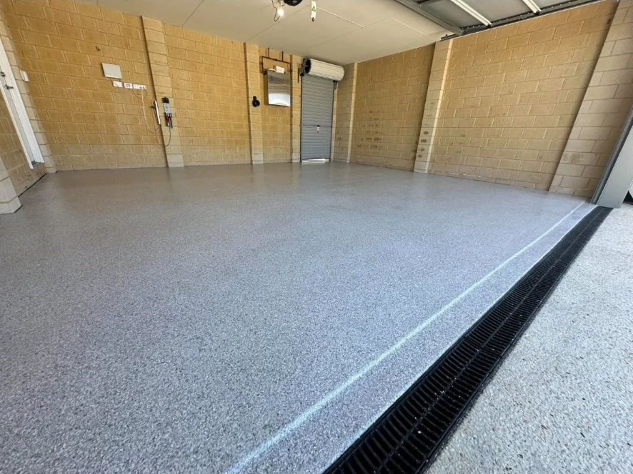 Wide view of a garage floor finished with grey flake epoxy
